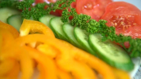 Cutting from vegetables. Yellow pepper, cucumber, parsley and tomato. Vegetable Stock Footage 75568233