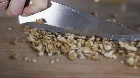 Cutting walnut kernels with knife in 4k, UHD Stock-Footage 81668867