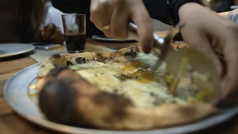 Cutting warm pizza on smaller pieces with roller-knife. Stock Footage 106721957