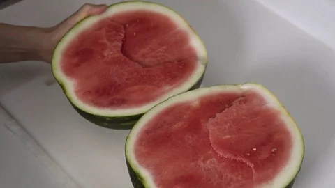 Cutting a Watermelon in half. 4K UHD. Stock Footage 77079351