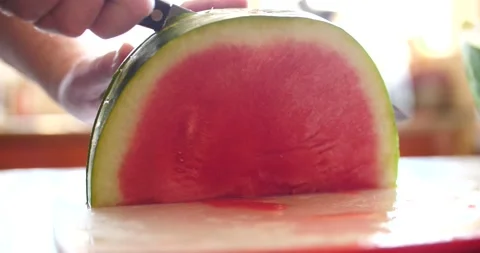 Cutting watermelon half with a large knife close-up on watermelon falling Stock Footage 205329863