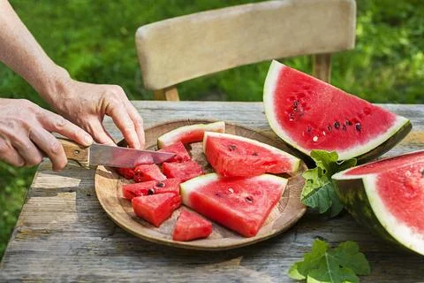 Cutting watermelon with knife Stock Photos