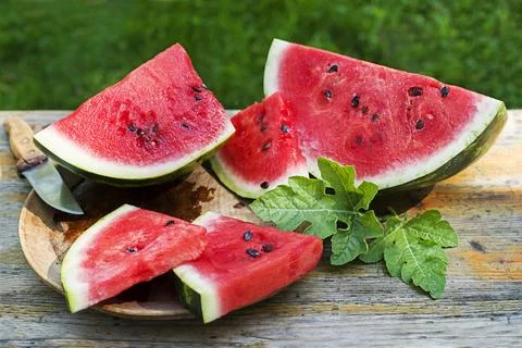 Cutting watermelon with knife Stock Photos