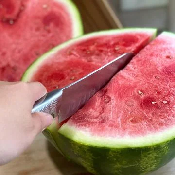 Cutting watermelon Stock Photos