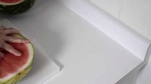 Cutting a Watermelon. Preparing to eat. 4K UHD. Stock Footage 77079399