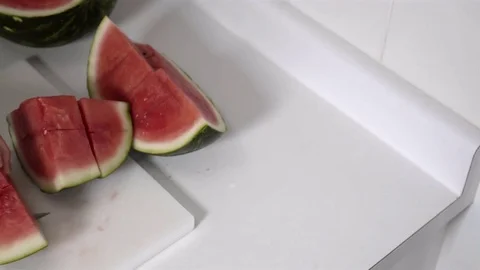 Cutting a Watermelon. Preparing to eat. 4K UHD. Stock Footage 77079574