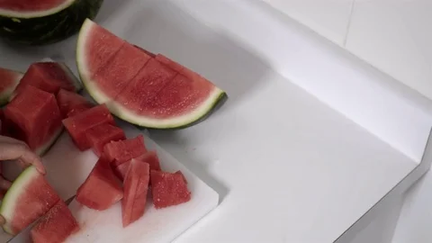 Cutting a Watermelon. Preparing to eat. 4K UHD. Stock Footage 77079816