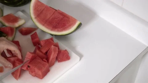 Cutting a Watermelon. Preparing to eat. 4K UHD. Stock Footage 77079923
