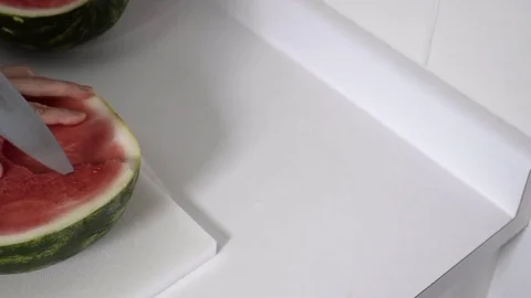 Cutting a Watermelon. Preparing to eat. 4K UHD. Stock Footage 77080385