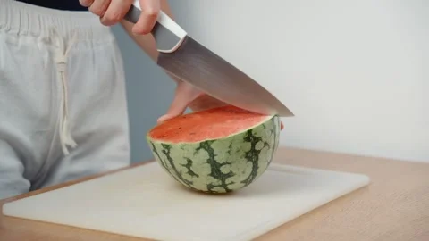 Cutting Watermelon into Quarters with Kitchen Knife Stock Footage 343937789
