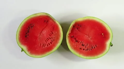 Cutting watermelon into two halves Stock Footage