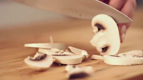 Cutting white champignons with a knife Stock Footage 56480958