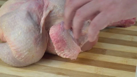 Cutting up a Whole Raw Chicken Stock Footage 125423484