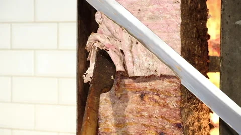 Cutting a whole thin slice of beef shawarma Video stock 207041077