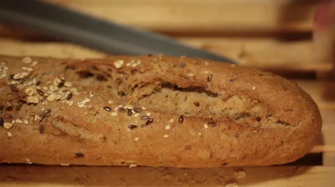 Cutting whole wheat bread baguette into small pieces Stock Footage 68455022