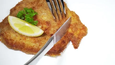 Cutting Wiener Schnitzel with fork and knife Stock Footage 272978150