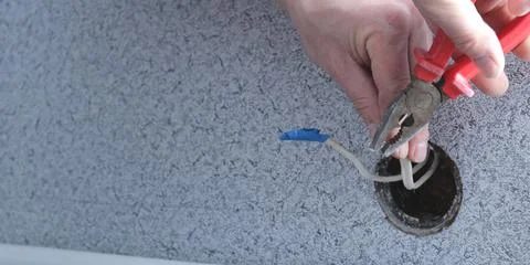 Cutting wires during socket replacement and space for text Stock Photos