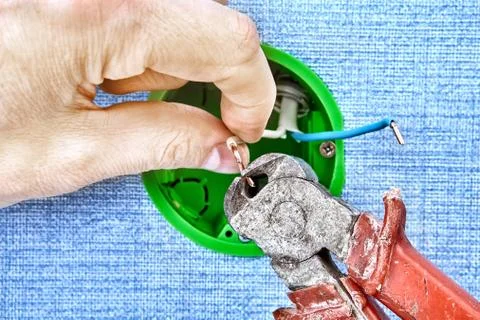 Cutting wiring with work tool. Stock Photos