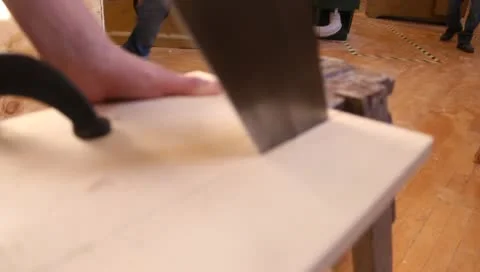 Cutting wood with handsaw Stock-Footage 10724820