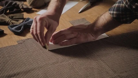 Cutting wool fabric. the line pattern. Bow ties of woolen fabric. Young man Stock Footage 83043784