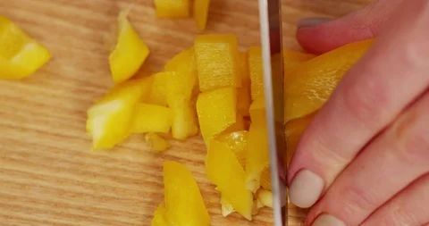 Cutting Yellow Bell Pepper with Knife on Wooden board Top view Stock Footage 124742458