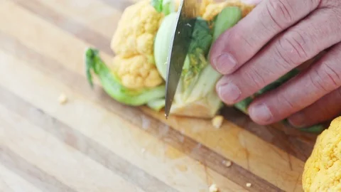 Cutting up a yellow cauliflower Stock Footage 90673150