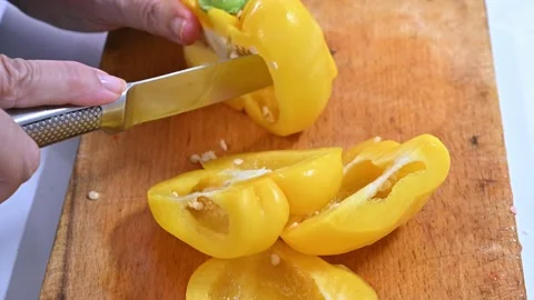 Cutting yellow pepper, on a table Stock Footage 219720527