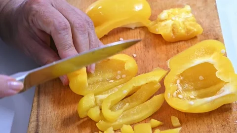 Cutting yellow pepper, on a table. In little pieces Stock Footage 219720581
