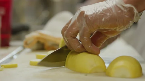 Cutting yellow squash chopping with a knife on cutting board Stock Footage 238951043