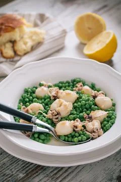 Cuttlefish with peas on a plate. High quality photo. Stock Photos