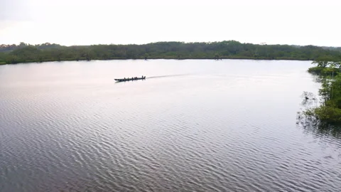 Cuyabeno, Ecuador, 25-12-2021: A canoe is driving over a lagoon in the forest Stock Footage 169965053