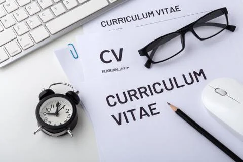CV, curriculum vitae with clock, computer keyboard, job interview, closeup Stock Photos