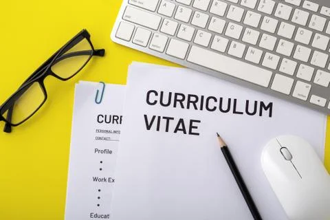 CV, curriculum vitae with computer keyboard, pencil on yellow table, top view Stock Photos