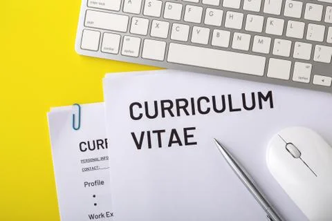 CV, curriculum vitae with computer keyboard, mouse, pen on yellow background, Stock Photos