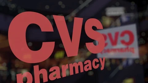 CVS Health logo on the glass against blurred business center. Editorial 3D Stock Footage