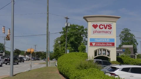 CVS Pharmacy store exterior with a bold red logo, large red awning and park.. 库存影片 335224226