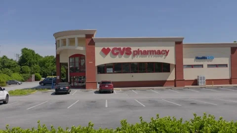CVS Pharmacy store exterior with a bold red logo, large red awning and park.. Stock Footage 335224248