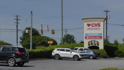 CVS Pharmacy store exterior with a bold red logo, large red awning and park.. Stock Footage 340575739