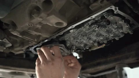 CVT gearbox close up, worker hands changing oil and making maintenance in new Stock-Footage 140291338