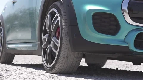 Cyan colored car drifting down a dirt road in slow motion on a sunny day Video stock 130408103