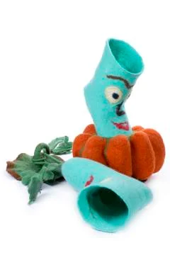 Cyan felt socks with a pattern on a white background with felted pumpkin Stock Photos