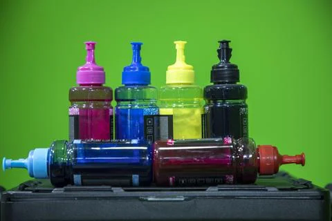 Cyan, magenta, yellow and black Ink jet refill colors in bottles Stock Photos