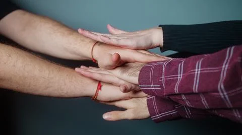 Cyan studio is placed on top of multiple hands in the background, Success and Foto stock