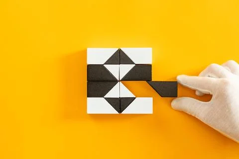 Cyber attack and data breach concept. Hand in white glove removing a block. Stock Photos