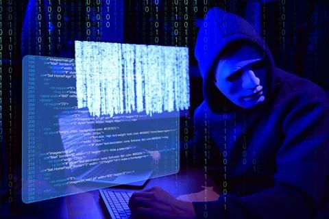 Cyber attack. Anonymous hacker in mask near computers in dark room. Binary .. Stock Photos