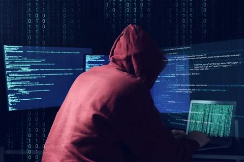 Cyber attack. Anonymous hacker working with laptop and monitors on dark blu.. Stock Photos