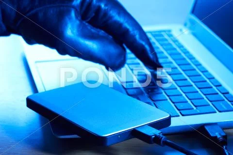Cyber Criminal Downloading Data Onto Portable Hard Drive Stock Photos