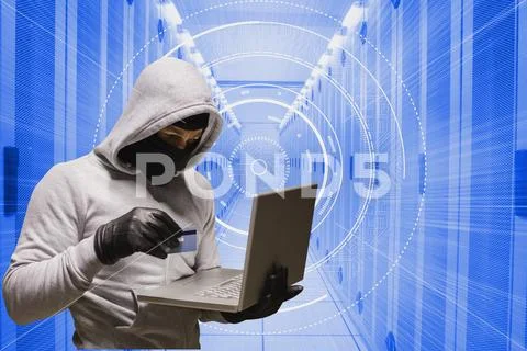 Cyber criminal is holding a credit card and a laptop against database background Stock Photos