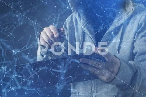 The cyber criminal, person using a tablet in deep web cyberspace. Stock Photos