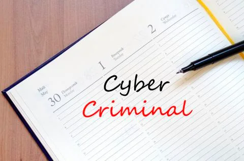 Cyber criminal write on notebook Stock Photos